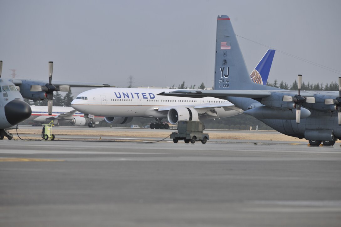 A United Airlines plane lands at Yokota Air Base, Japan, after diverting from Tokyo’s Narita International Airport, March 11, 2011. Yokota opened its airfield to diverted air traffic following a major earthquake off the Japanese coast. U.S. Air Force photo by Master Sgt. Kimberly Spinner