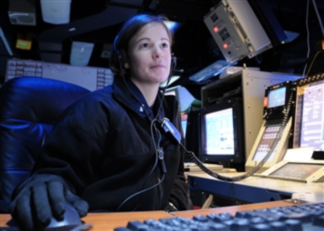 U.S. Navy Lt. j.g. Sara Everett, a Combat Direction Center watch officer, reviews intelligence slides aboard the aircraft carrier USS Ronald Reagan (CVN 76) while the ship is underway in the Pacific Ocean on March 4, 2011.  