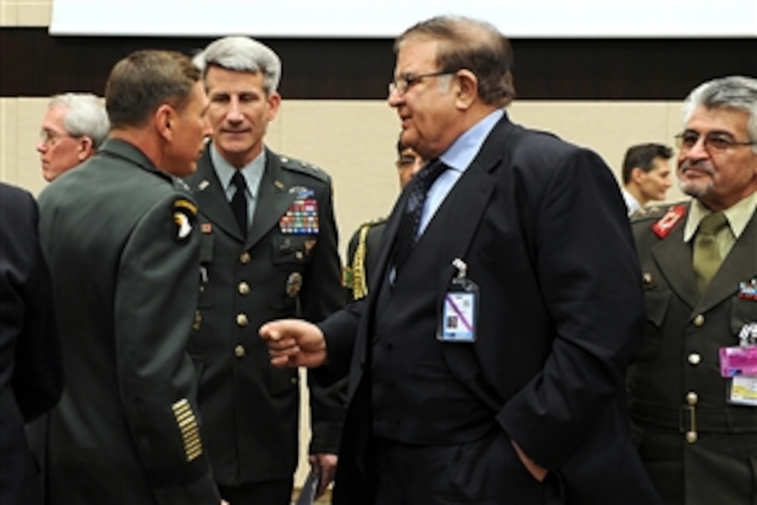 Defense Minister of Afghanistan Abdul Rahim Wardak (right) speaks with Commander NATO International Security Assistance Force and U.S. Forces Afghanistan Gen. David H. Petraeus (left) and ISAF Deputy Chief of Staff of Operations Maj. Gen. John W. Nicholson (2nd from left) at the NATO headquarters in Brussels, Belgium, on March 11, 2011.  Gates is in Belgium to attend NATO Defense Ministers' meetings.  DoD photo by Cherie Cullen.  (Released)  