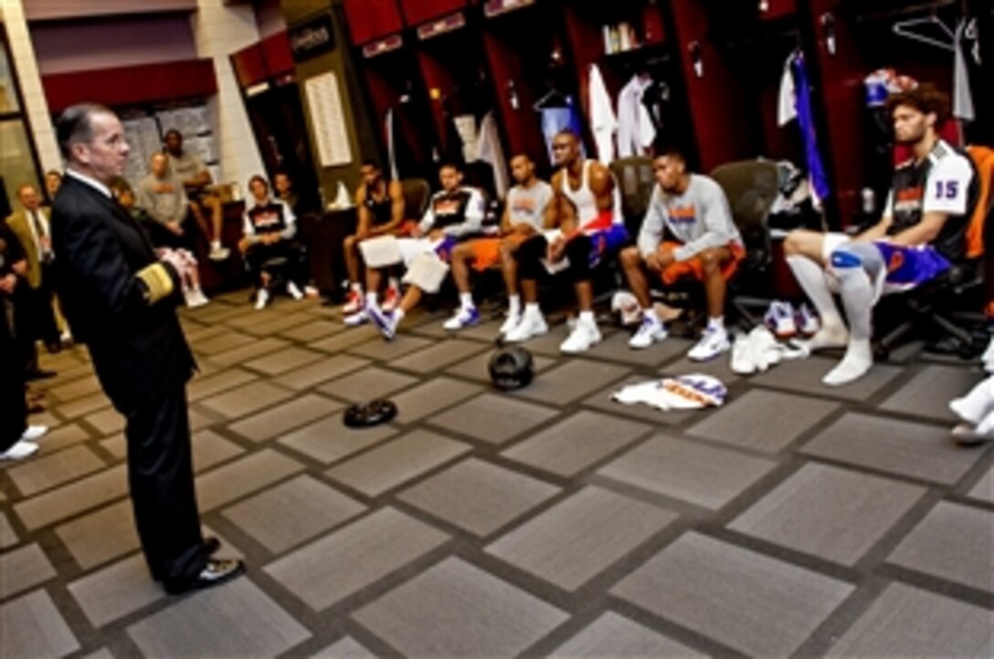 Navy Adm. Mike Mullen, chairman of the Joint Chiefs of Staff, speaks with members of the Phoenix Suns basketball team at Sun Stadium in Phoenix, Ariz., March 10, 2011. Mullen visited Phoenix to speak with local and state officials during his continuing "Conversation with the Country" tour.