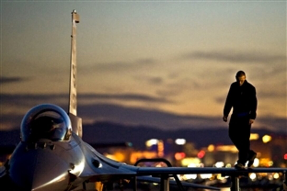 U.S. Air Force Airman 1st Class Jeremy Hunt inspects the wing of an F-16 Fighting Falcon  during Red Flag, an advanced aerial combat training exercise, on Nellis Air Force Base, Nev., March 2, 2011. Hunt is a crew chief assigned to the 20th Fighter Wing at  Shaw Air Force Base, S.C.