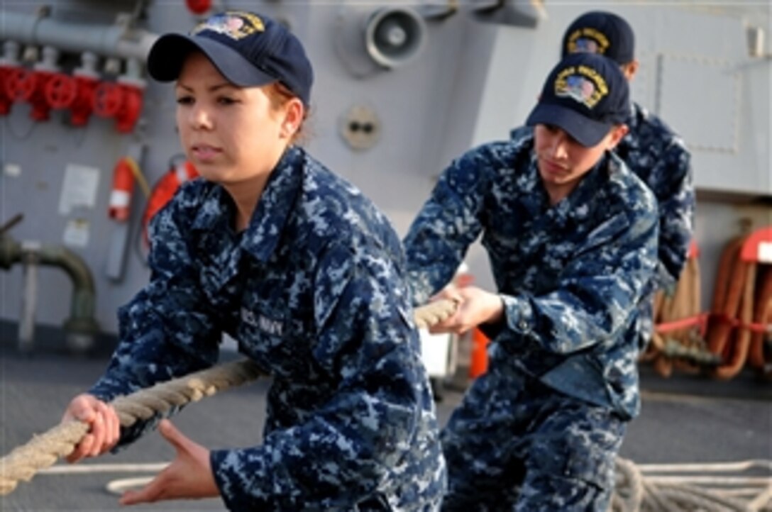 Seaman Erika Berry and Seaman Robert Toohey heave a line during sea and anchor detail aboard the guided-missile destroyer USS Decatur (DDG 73) near Mina Salman, Bahrain, on March 9, 2011.  The Decatur is on routine deployment conducting maritime security operations in the U.S. 5th Fleet area of responsibility.  
