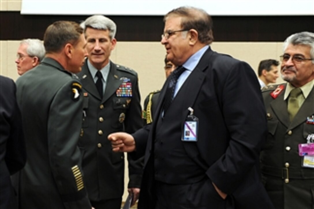 Defense Minister of Afghanistan Abdul Rahim Wardak (right) speaks with Commander NATO International Security Assistance Force and U.S. Forces Afghanistan Gen. David H. Petraeus (left) and ISAF Deputy Chief of Staff of Operations Maj. Gen. John W. Nicholson (2nd from left) at the NATO headquarters in Brussels, Belgium, on March 11, 2011.  Gates is in Belgium to attend NATO Defense Ministers' meetings.  DoD photo by Cherie Cullen.  (Released)  