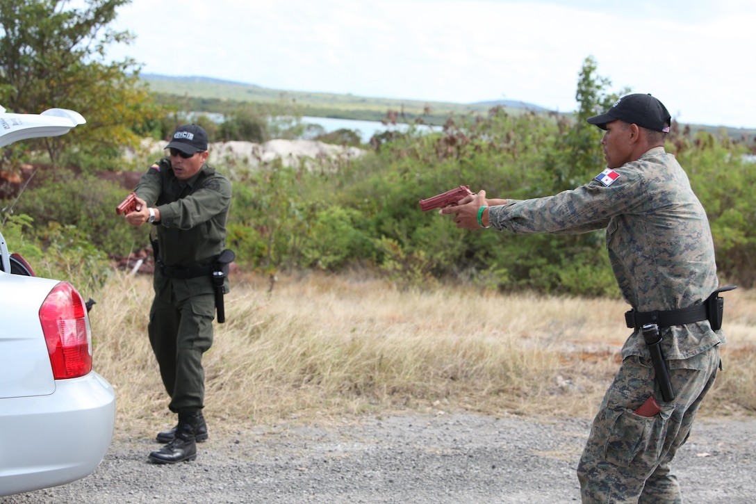 Columbia National Police Sgt. Julian Rey (left) and Panama National Air-Naval Service Cabl. 1 Alejandro Moya (right), conduct a mock vehicle search as part of exercise Tradewinds 2011.