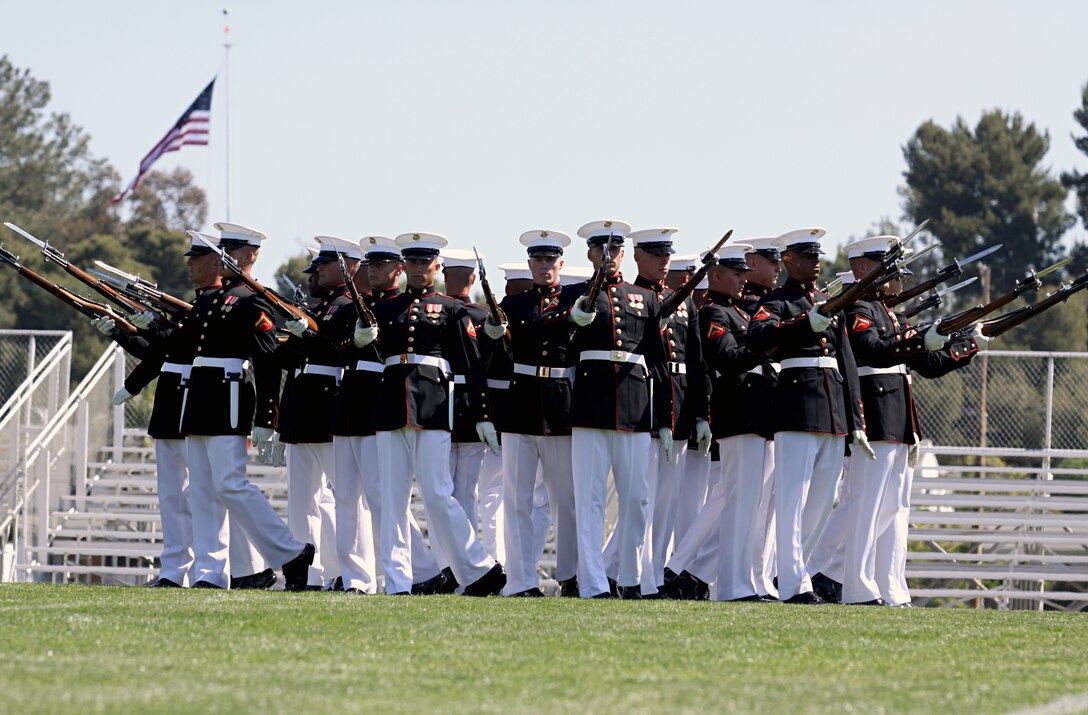The Silent Drill Platoon performs during the annual Battle Colors ceremony at Camp Pendleton’s Paige Field House, March 11. The 24-man platoon displayed their precise, calculated drill movements by flinging ten-pound M1 rifles from Marine-to-Marine without any verbal commands.