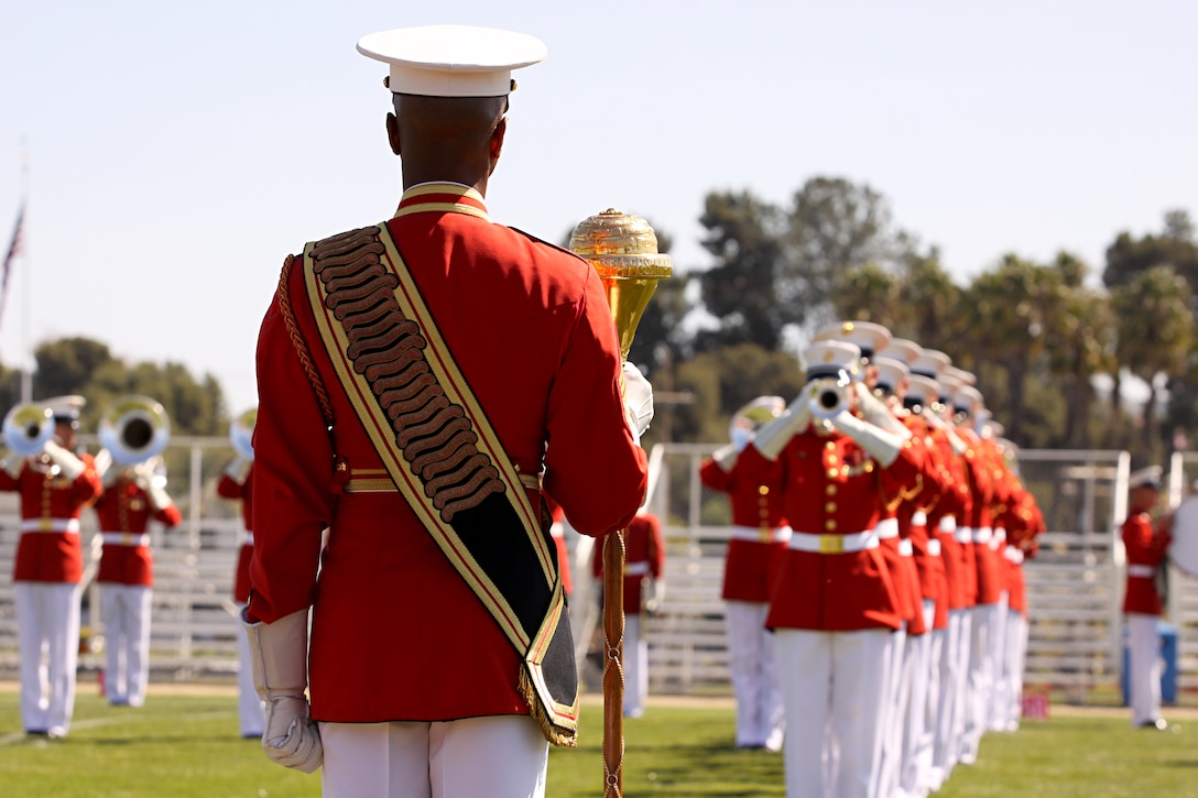 Master Sgt. Kevin Buckles, drum major with the U.S. Marine Drum and Bugle Corps, Marine Barracks Washington, directs more than 80 Marine musicians during the annual Battle Color Ceremony at Camp Pendleton’s Paige Fieldhouse, March 11. Also known as “The Commandant’s Own,” the Drum and Bugle Corps is comprised of more than 80 Marine musicians and is currently the only one of its kind in the U.S. Armed Forces.