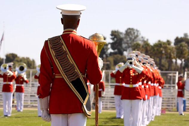 Master Sgt. Kevin Buckles, drum major with the U.S. Marine Drum and Bugle Corps, Marine Barracks Washington, directs more than 80 Marine musicians during the annual Battle Color Ceremony at Camp Pendleton’s Paige Fieldhouse, March 11. Also known as “The Commandant’s Own,” the Drum and Bugle Corps is comprised of more than 80 Marine musicians and is currently the only one of its kind in the U.S. Armed Forces.