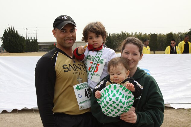 Gerard V Fontenot and family show off Simon Fontenot's second place medal for the category six-years-old and under during the 2011 St. Patrick's Day Run on the Green. Gerard Fontenot ran with his son during the 2.5K youth run and continued after his son had finished to complete the 5K run.