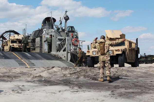 Marines from Tank Platoon, Alpha Company, Battalion Landing Team 1/1, 13th Marine Expeditionary Unit, perform daily maintenance on one of their M1-A1 Abrams Main Battle tanks while aboard the USS Green Bay, March 11, 2011. The Marines perform this maintenance to prevent salty and moist air from corroding the metal on the tanks. The ship has the capability of storing a variety of vehicles and cargo such as tanks, amphibious assault vehicles and quadcons.::r::::n::(Official U.S. Marine Corps photo by Cpl. Christopher O’Quin)(Released)::r::::n::