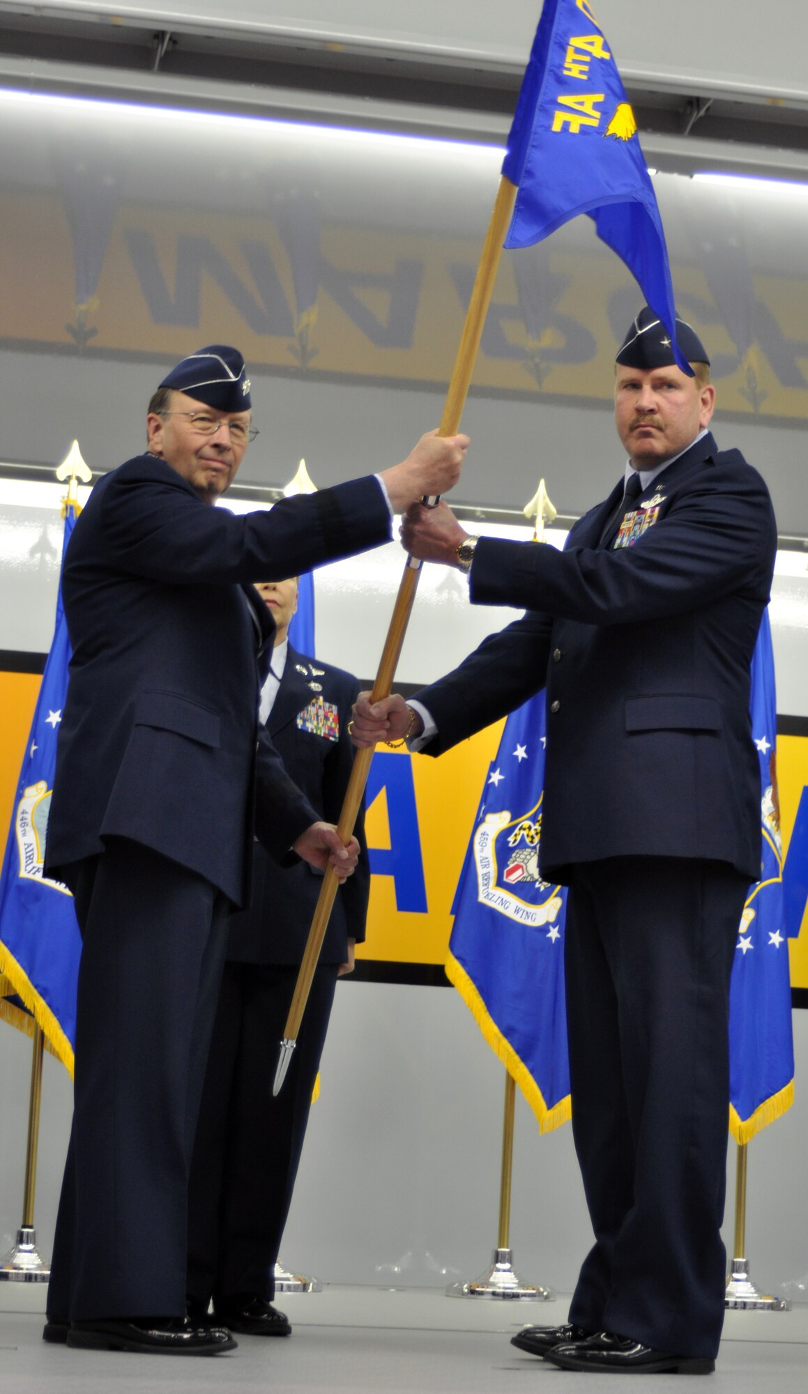Brig. Gen. Mark A. Kyle accepts the 4th Air Force guidon from Lt. Gen. Charles E. Stenner, chief of Air Force Reserve, Headquarters, U.S. Air Force, Washington D.C., and commander, Air Force Reserve Command, Robins Air Force Base, Ga., during a change of command ceremony at March Air Reserve Base, Calif., March 12, 2011.  General Kyle is the new commander of 4th Air Force, taking the place of the former commander, Maj. Gen. Eric W. Crabtree. (U.S. Air Force photo/Master Sgt. Linda Welz)