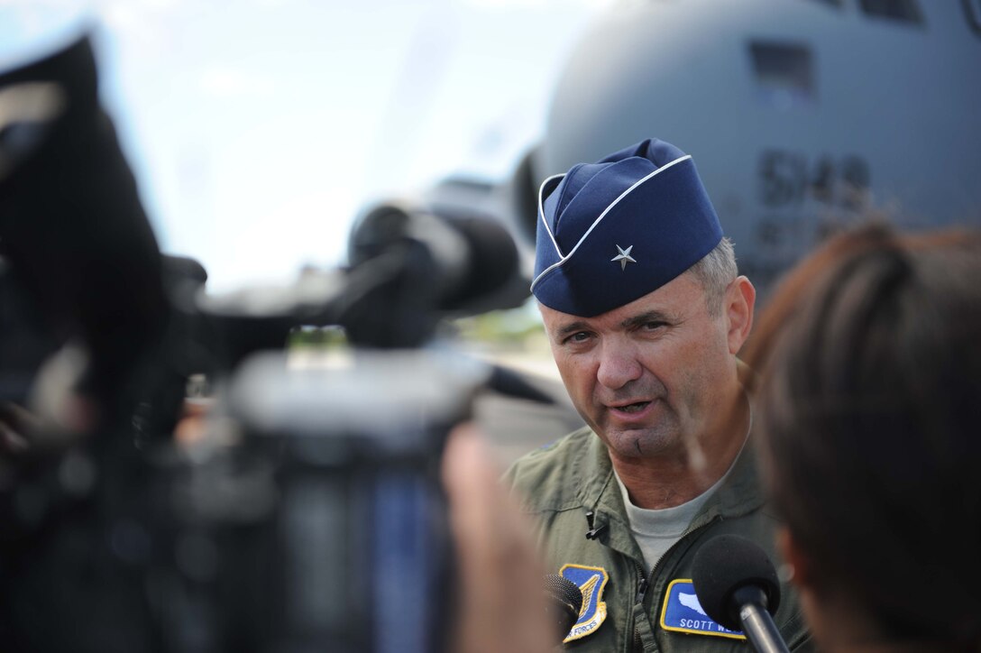 Brig. Gen. Scott West, 13th Air Force vice commander, fields questions from the media before boarding a C-17 preparing to depart on a humanitarian mission to Japan Mar. 12 at Joint Base Pearl Harbor-Hickam, Hawaii. The plane will visit various Air Force bases in Japan during its mission to to provide support for Japan relief efforts in the wake of tsunami and earthquake damage there. (U.S. Air Force photo by Staff Sgt. Nathan Allen)