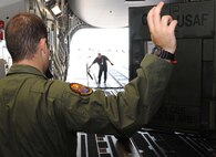 Airman Ryan Lockhart, 535th Airlift Squadron loadmaster, directs the loading of a generator into the cabin of a C-17 in preparation for its departure on a  humanitarian mission to Japan Mar. 12 at Joint Base Pearl Harbor-Hickam, Hawaii. The plane will visit various Air Force bases in Japan during its mission to to provide support for Japan relief efforts in the wake of tsunami and earthquake damage there. (U.S. Air Force photo by Staff Sgt. Nathan Allen)