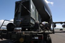 A 735th Air Mobility Squadron ramp service technician loads generators onto a C-17 in preparation for its departure on a  humanitarian mission to Japan Mar. 12 at Joint Base Pearl Harbor-Hickam, Hawaii. The plane will visit various Air Force bases in Japan during its mission to to provide support for Japan relief efforts in the wake of tsunami and earthquake damage there. (U.S. Air Force photo by Staff Sgt. Nathan Allen)