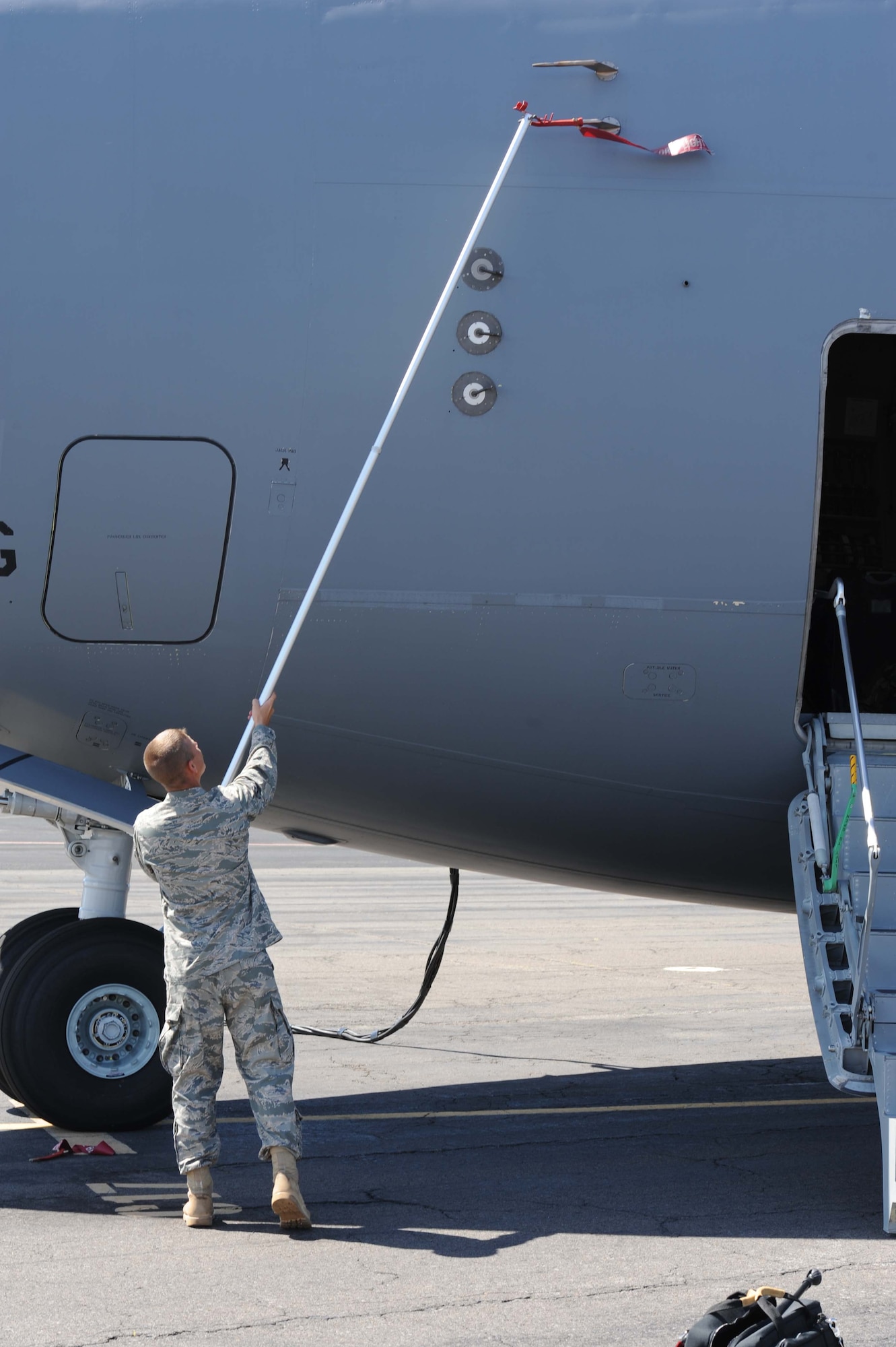 Staff Sgt. Eric Jordan, 15th Aircraft Maintenance Squadron crew chief, removes pitot covers during a pre-flight maintenance inspection on a C-17 before departing on a  humanitarian mission to Japan Mar. 12 at Joint Base Pearl Harbor-Hickam, Hawaii. The plane will visit various Air Force bases in Japan during its mission to to provide support for Japan relief efforts in the wake of tsunami and earthquake damage there. (U.S. Air Force photo by Staff Sgt. Nathan Allen)