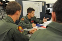 Capt. Nate Amidon, 535th Airlift Squadron pilot, conducts a pre-flight crew briefing before departing on a  humanitarian mission to Japan Mar. 12 at Joint Base Pearl Harbor-Hickam, Hawaii. The plane will visit various Air Force bases in Japan during its mission to to provide support for Japan relief efforts in the wake of tsunami and earthquake damage there. (U.S. Air Force photo by Staff Sgt. Nathan Allen)