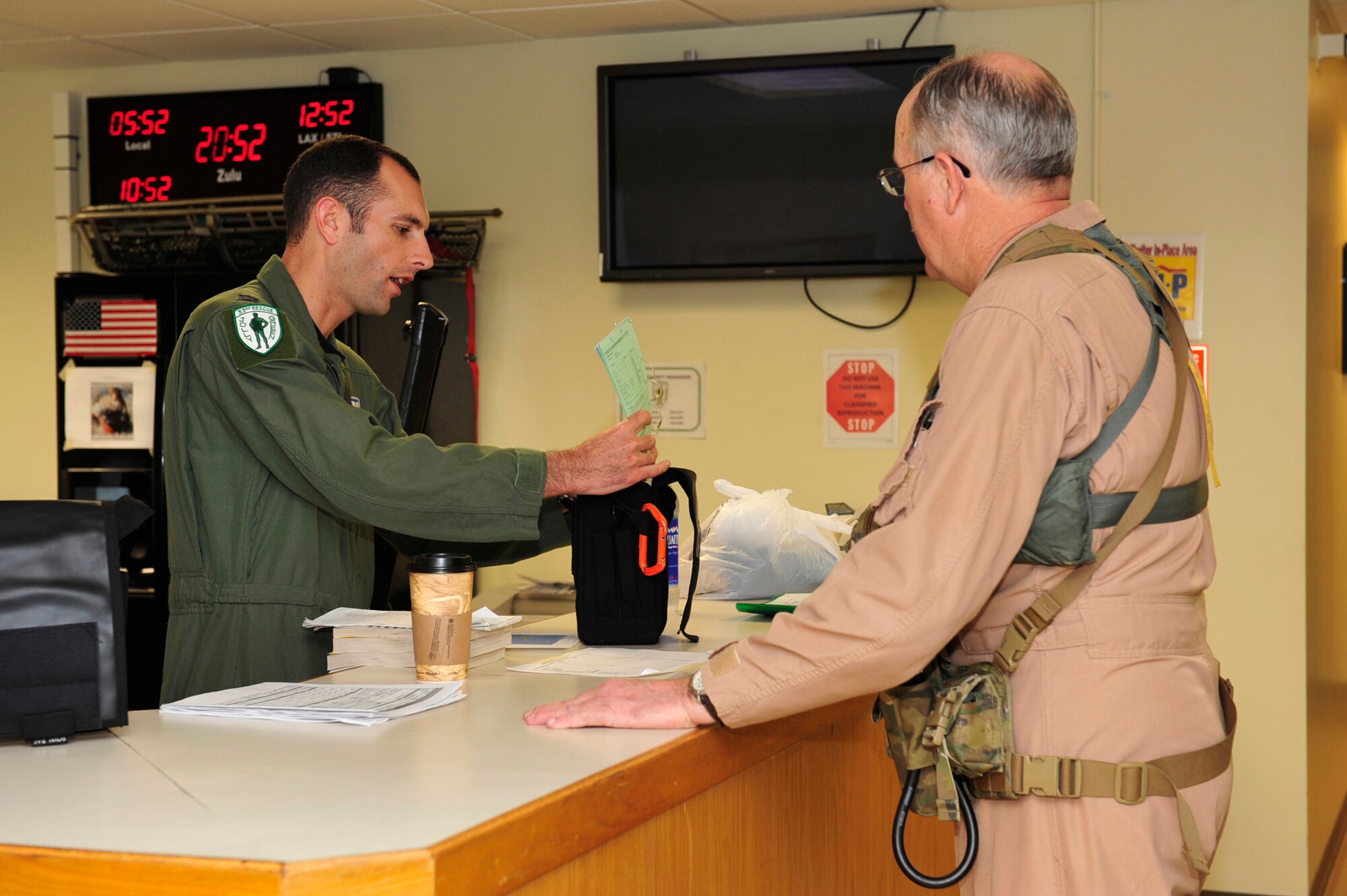 Capt. Gabe Brown, aircraft commander and James Turnage, a maintenance flight test pilot both with the 33rd Rescue Squadron, discuss aspects of the mission before taking off to mainland Japan, here at Kadena Air Base , March 13. The 33rd RQS plan to assist in search and rescue following the earthquake and tsunami that struck mainland Japan Friday afternoon. (U.S. Air Force photo/Staff Sgt. Lakisha A. Croley)
