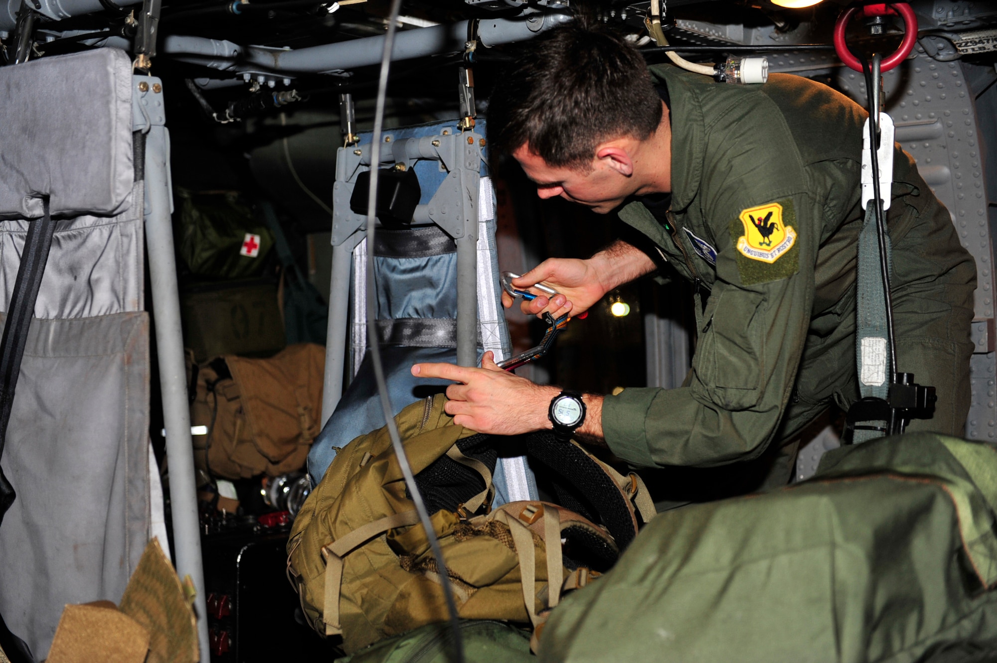 Staff Sgt. Tyson Reams, a flight engineer and gunner for the 33rd Rescue Squadron packs equipment onto an HH-60 Pavehawk before taking off for mainland Japan, here at Kadena Air Base, March 13. Along with 33rd RQS members, 100 plus Kadena members will be providing medical attention and assistance with restoring electric power in support of  disaster relief subsequent Friday's earthquake and tsunami. (U.S. Air Force photo/Staff Sgt. Lakisha A. Croley)