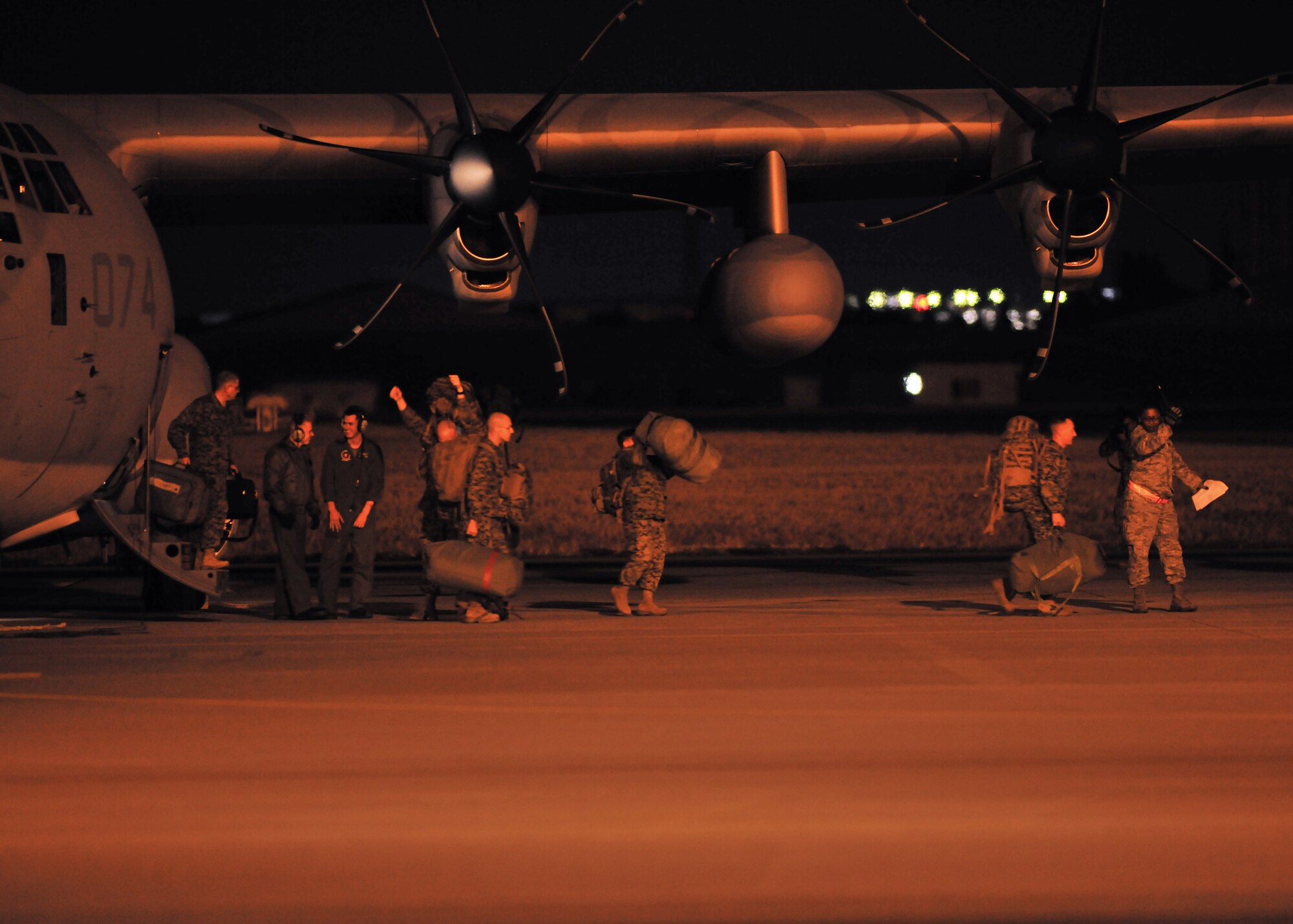YOKOTA AIR BASE, Japan -- The first wave of American disaster relief forces exits a KC-130J aircraft here March 12. They are here to assist with Japan's earthquake and tsunami recovery effort.  (U.S. Air Force photo/Master Sgt. Kimberly Spinner)
