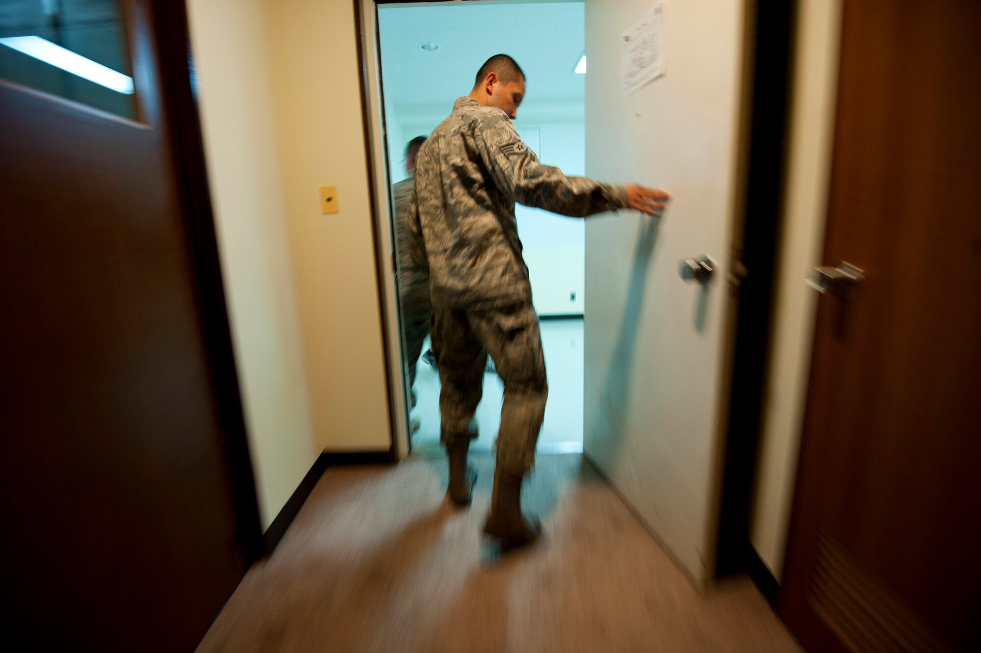 YOKOTA AIR BASE, Japan -- Airman 1st Class Eli Diaz, 374th Communications Squadron, exits a freshly cleaned apartment here March 12. Airman Diaz worked with a team of volunteers and other Airmen to prepare one of the residential towers at Yokota AB for receiving incoming transient aircrew. (U.S. Air Force photo/Staff Sgt. Samuel Morse)