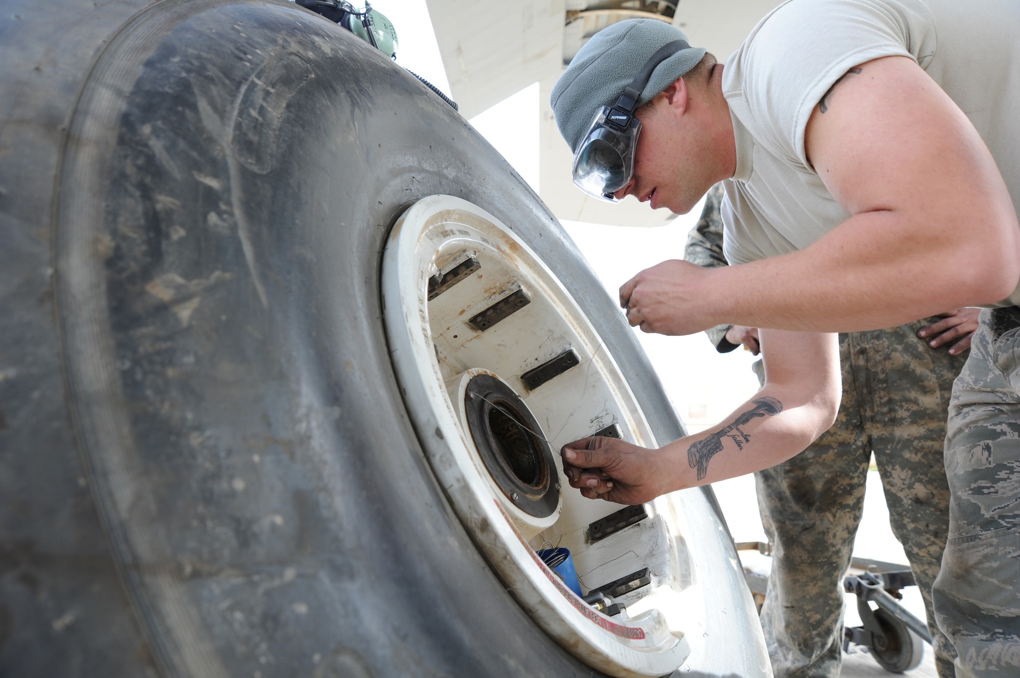 JOINT BASE BALAD, Iraq-- Staff Sgt. Justin Sherman, 777th Expeditionary Aircraft Maintenance Unit C-130 Hercules crew chief, wires the main landing gear’s axle bearing plate for safety during a routine tire change, March 12, 2011.  Sergeant Sherman hails from Fort Worth, Texas and is deployed from Little Rock Air Force Base, Ark.  (U.S. Air Force photo/ Staff Sgt. Keyonna Fennell)








































































































































































































































































































































































































































































































































































































































































































































































































































