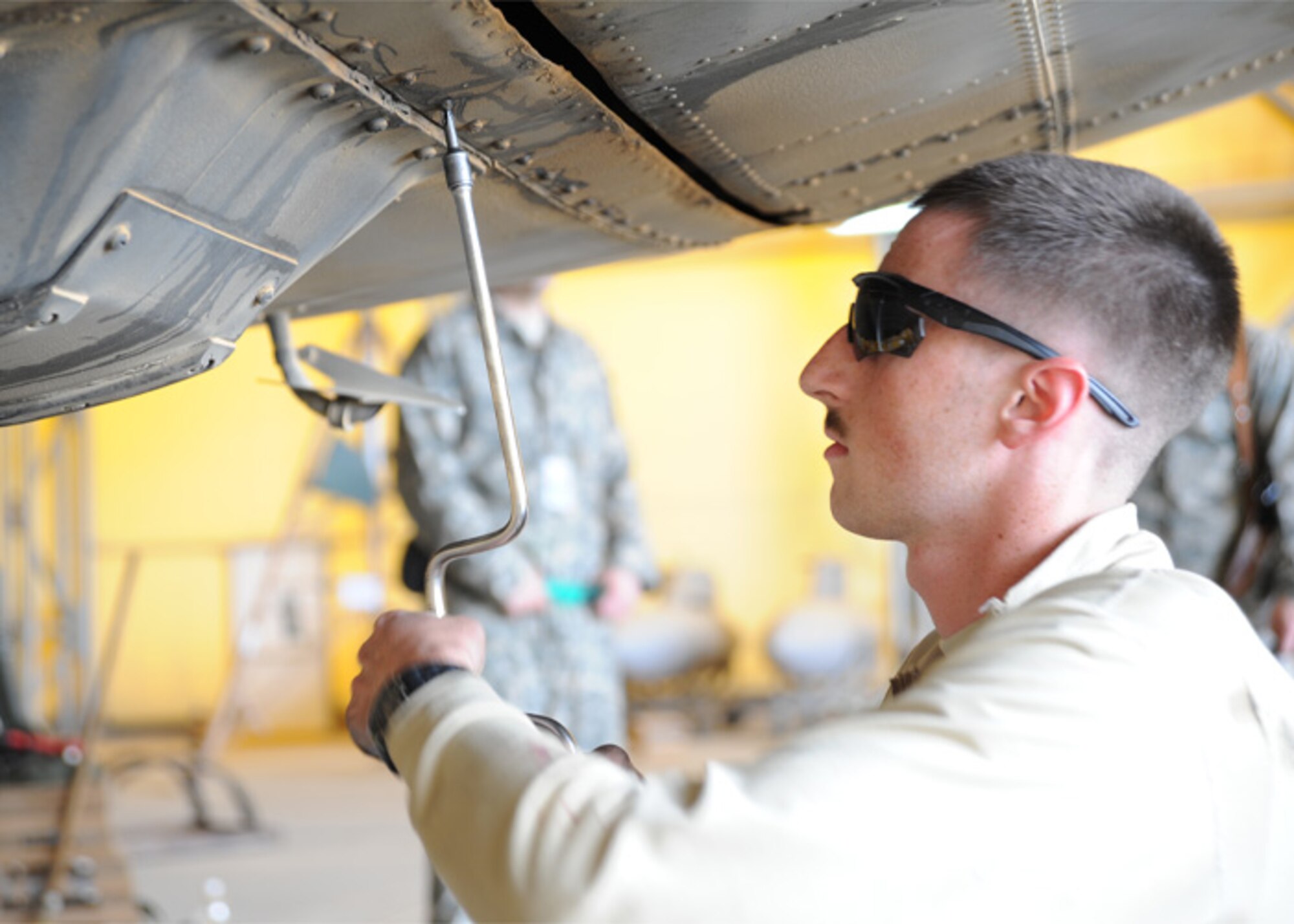 JOINT BASE BALAD, Iraq-- Airman 1st Class Nicholas Spase, 777th Expeditionary Aircraft Maintenance Unit C-130 Hercules crew chief, uses a speed handle to check screws for washers during a major inspection March 12, 2011. Airman Spase is a native of Schertz, Texas and is deployed from Little Rock Air Force Base, Ark. (U.S. Air Force photo/Staff Sgt. Keyonna Fennell)