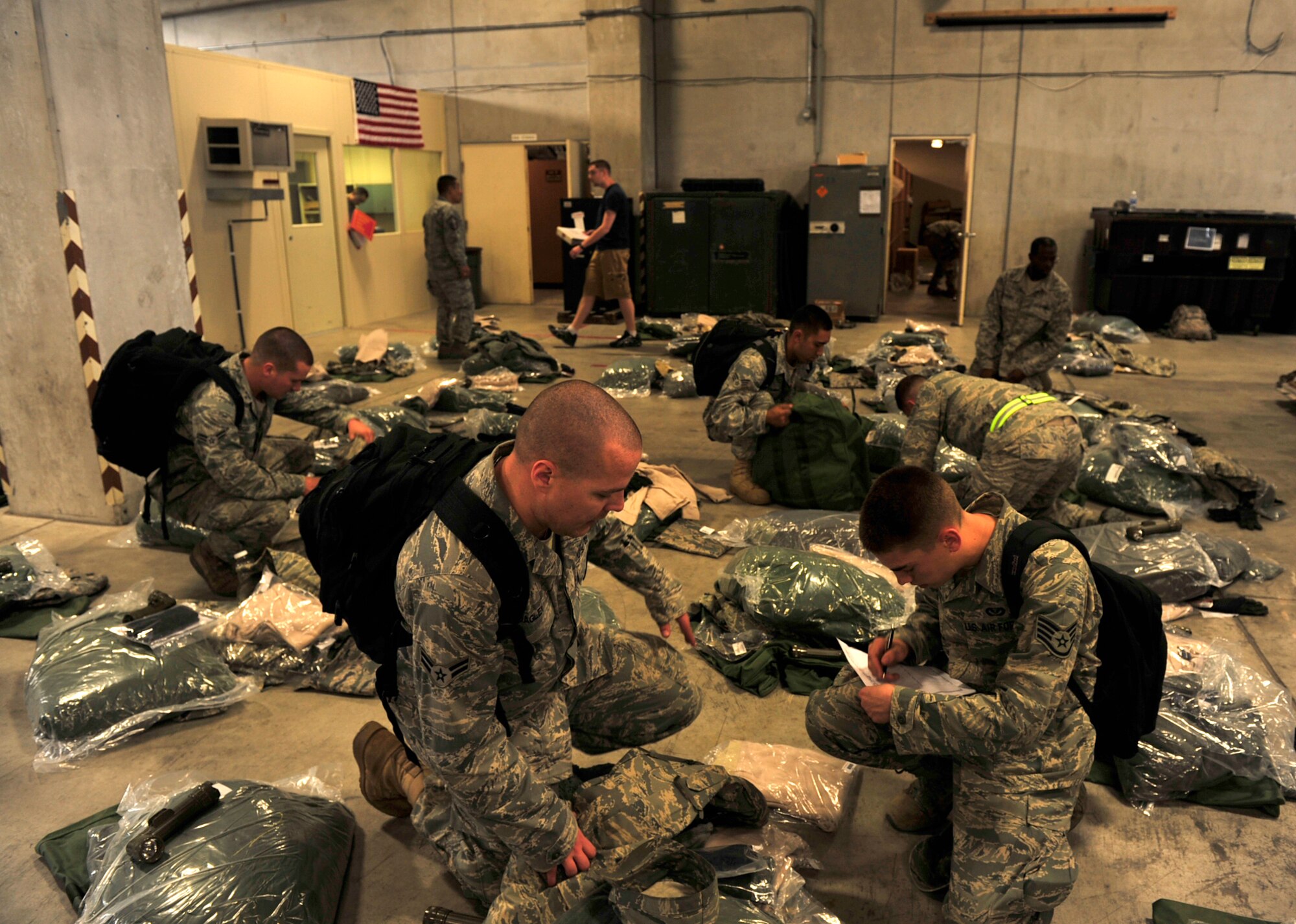 Airman 1st Class Michael Bagley and Staff Sgt. Ryan Miller from the 18th Civil Engineer Squadron go over a checklist to ensure they have all of their equipment March 12 at Kadena Air Base. More than 50 members of the 18th CES deployed to Misawa Air Base in northern Japan to help restore power and basic services there. (U.S. Air Force photo / Staff Sgt. Lakisha Croley)