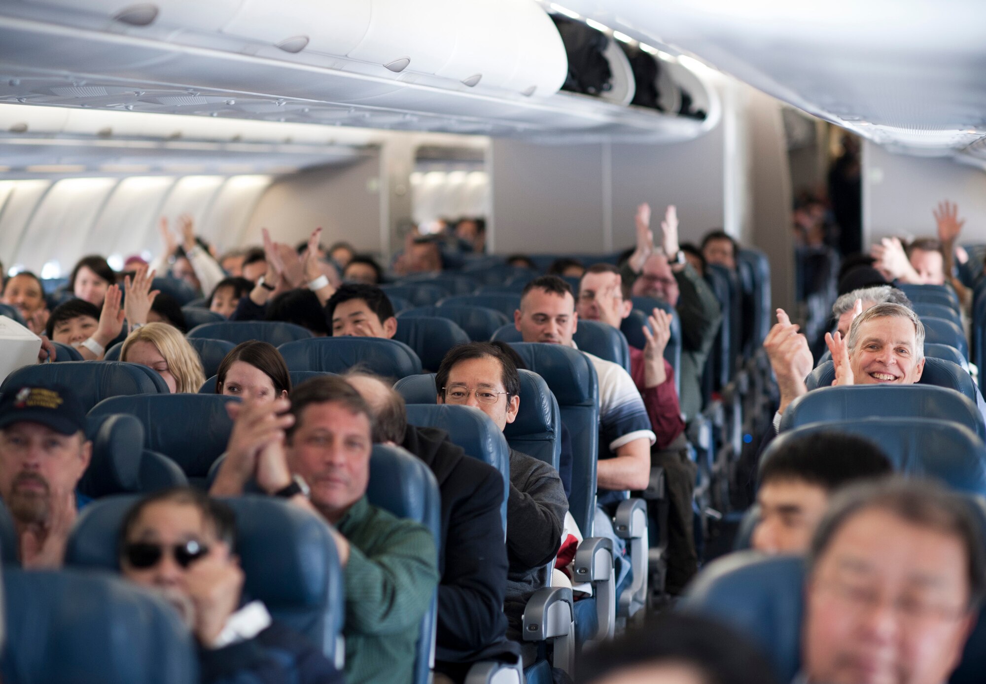 YOKOTA AIR BASE, Japan -- Passengers aboard a Delta Air Lines flight here March 12, applaud the efforts of the Yokota Airmen who received and took care of them the previous night. The aircraft was diverted to Yokota from Narita International Airport in Tokyo, Japan, after an 8.9 magnitude earthquake struck off the eastern coast of Japan the day before. (U.S. Air Force photo/Staff Sgt. Samuel Morse)