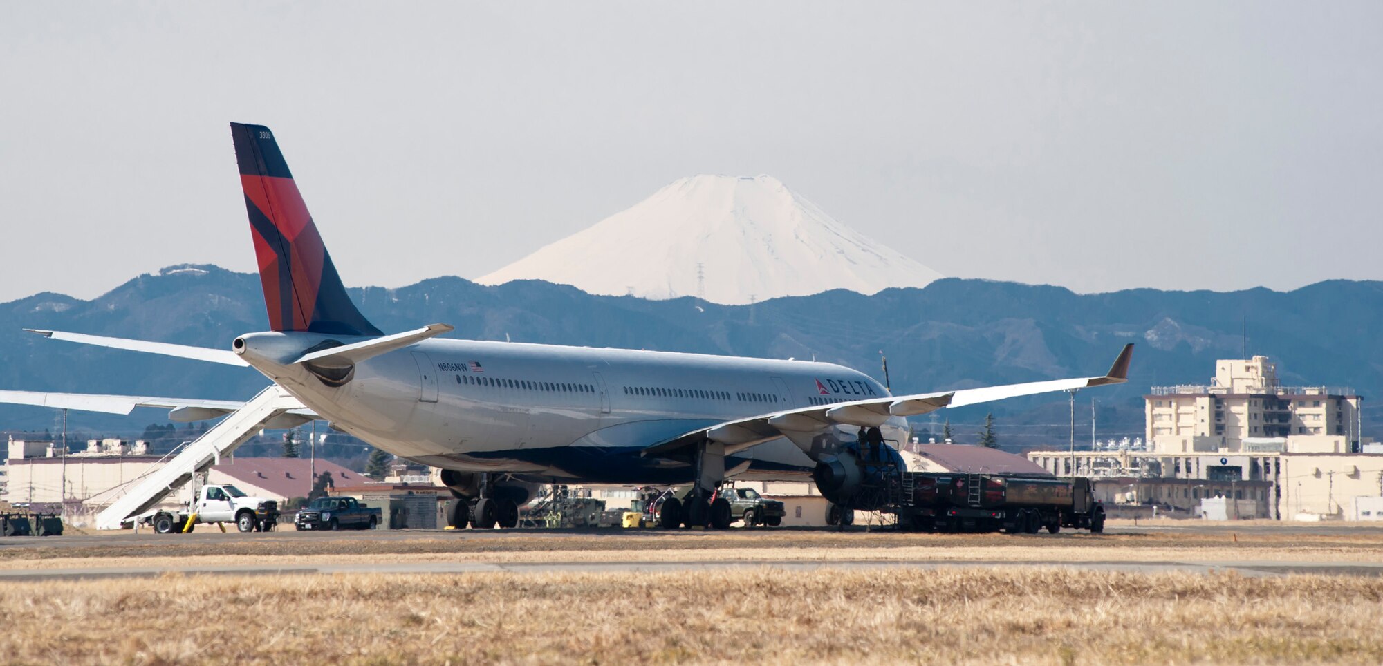 YOKOTA AIR BASE, Japan -- Airmen from the 374th Logistics Readiness Squadron refuel a Delta Air Lines aircraft here March 12, after being diverted from Narita International Airport in Tokyo, Japan, the day before following an earthquake that struck off the eastern coast of Japan. (U.S. Air Force photo by Staff Sgt. Samuel Morse)