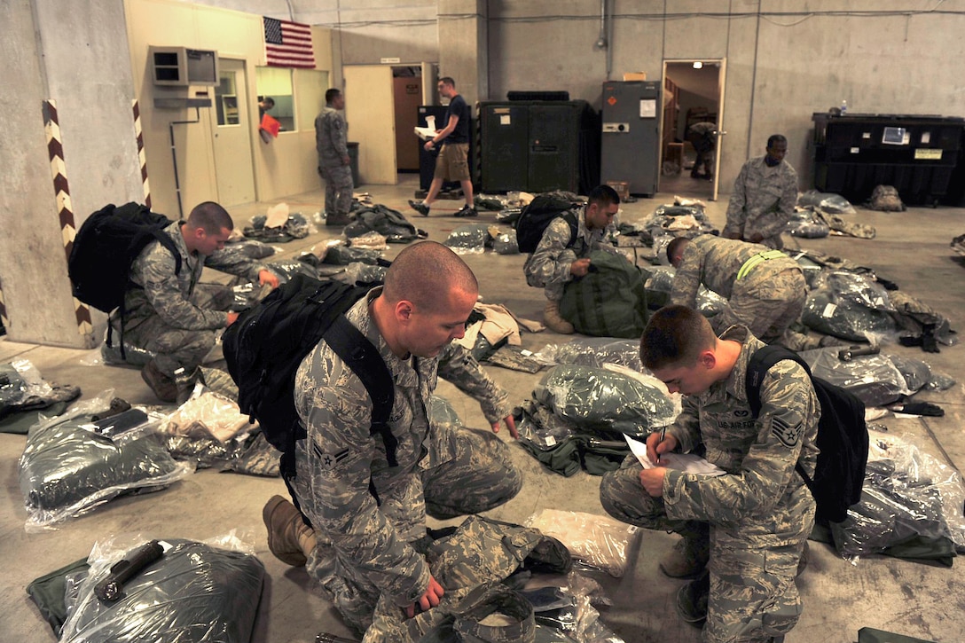 U.S. Air Force airmen go over checklist and prepare mobility bags to Misawa Air Base, at Kadena Air Base, March 12, 2011. The airmen, assigned to the 18th Civil Engineer Group will assist Misawa personnel with regaining the electric and power capabilities.