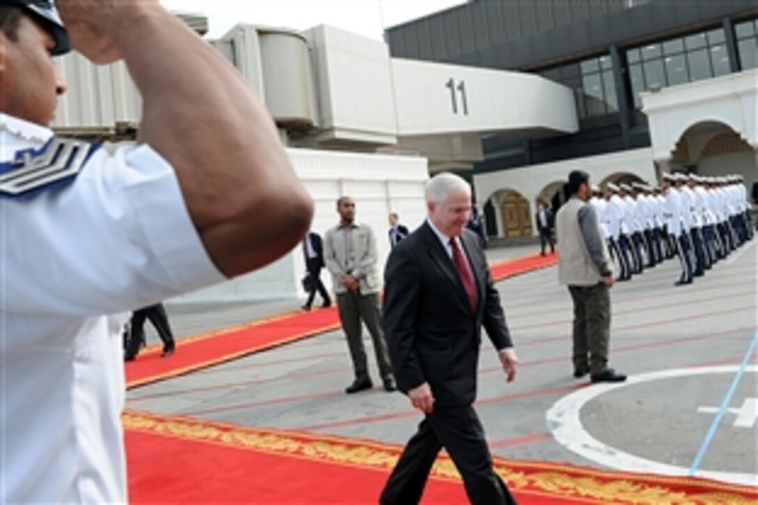 U.S. Defense Secretary Robert M. Gates prepares to board a plane in Bahrain, March 12, 2011.  