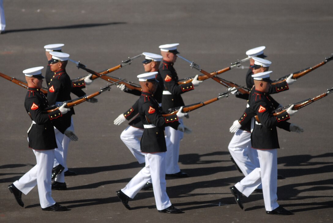 The Silent Drill Platoon performed complex drill movements across the black parade deck March 12, wearing sharp dress blue uniforms, they slapped their gloves against hand-polished 10-and-a-half-pound, to stay in harmony with one another.