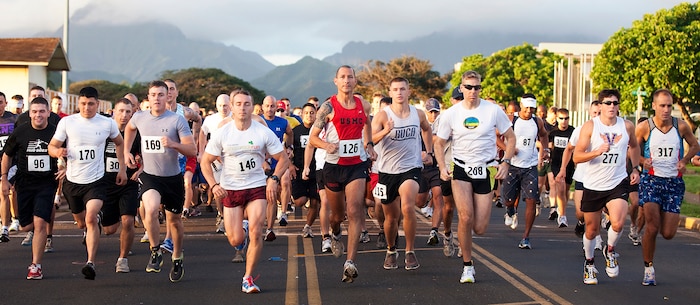 At the middle in red, Staff Sgt. Tyler Hubbard, the substance abuse and control officer for Headquarters Battalion, Marine Corps Base Hawaii, bolts from the starting line during 3rd Marine Regiment’s 8th annual “The Beast” 10K run on base, March 12, 2011. Competing against 335 other military and civilian participants, Hubbard endured the challenging course’s hills and fresh mud to win first place overall.