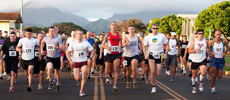 At the middle in red, Staff Sgt. Tyler Hubbard, the substance abuse and control officer for Headquarters Battalion, Marine Corps Base Hawaii, bolts from the starting line during 3rd Marine Regiment’s 8th annual “The Beast” 10K run on base, March 12, 2011. Competing against 335 other military and civilian participants, Hubbard endured the challenging course’s hills and fresh mud to win first place overall.