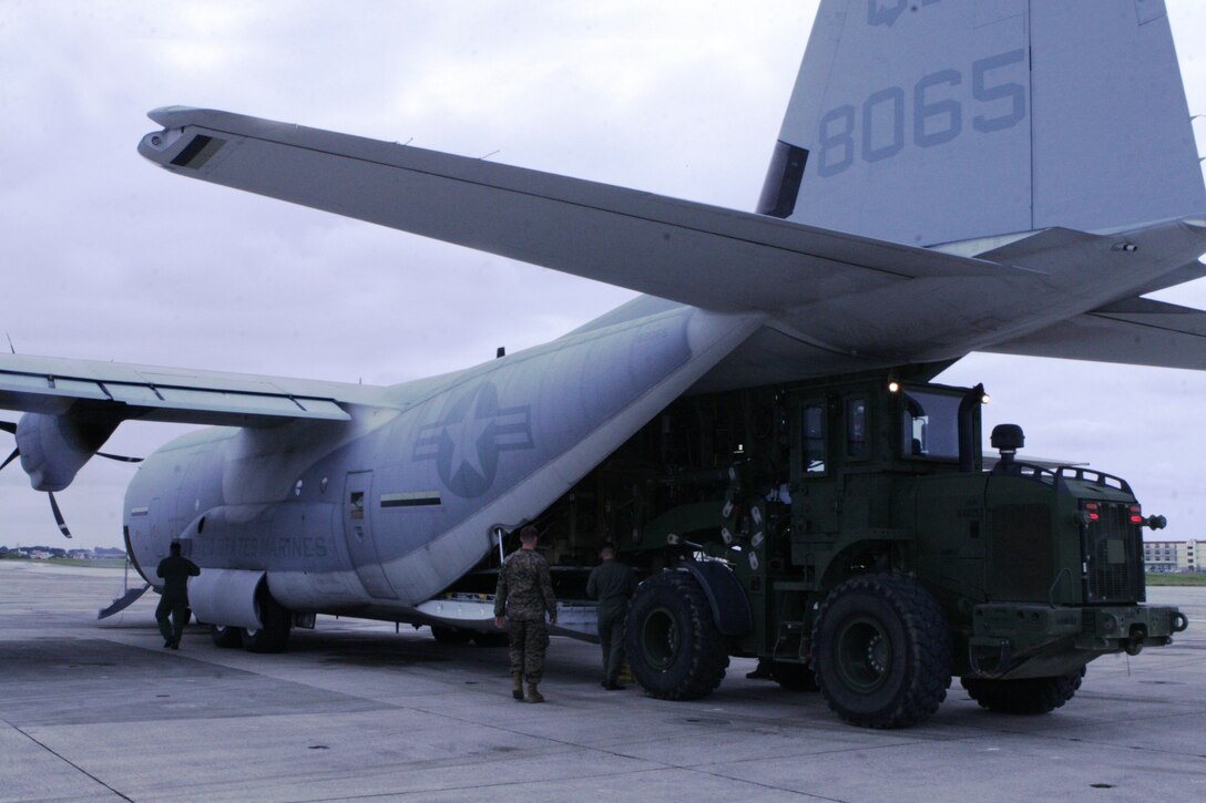 Marines from III Marine Expeditionary Force load supplies and equipment onto a KC-130J Super Hercules aircraft at Marine Corps Air Station Futenma March 13. The supplies will be delivered to mainland Japan to be used in humanitarian assistance operations following the earthquake and tsunami that struck northern Japan March 11. The proximity of Marine Corps aviation assets at MCAS Futenma has allowed Marines from III MEF to rapidly deploy critically-needed supplies and aid to support the relief effort.