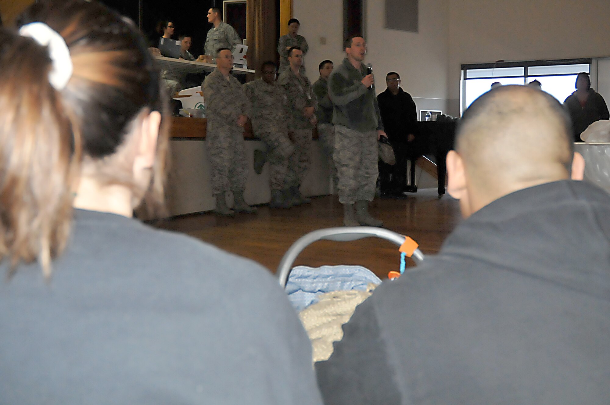 MISAWA AIR BASE, Japan -- Base residents listen as Col. Michael Rothstein, 35th Fighter Wing commander, briefs them on the current conditions of the base Mar. 12. The base lost power after they felt the effects of an 8.9 magnitude earthquake that hit 100 miles off the coast of Northern Japan Mar. 11. (U.S. Air Force photo by Staff Sgt. Marie Brown\Released)
