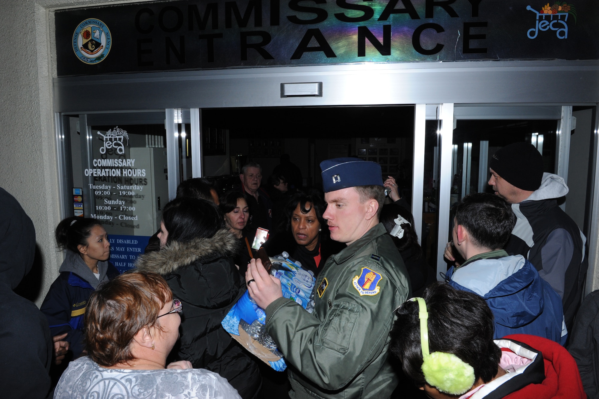 MISAWA AIR BASE, Japan -- Residents receive a case of water from the base Commissary after an earthquake knocked out the power to the base Mar. 11. An 8.9 magnitude earthquake hit 100 miles off the coast of northern Japan and is on record as being the worst earthquake in the history of Japan. (U.S. Air Force photo by Tech. Sgt. Russell McBride\Released)
