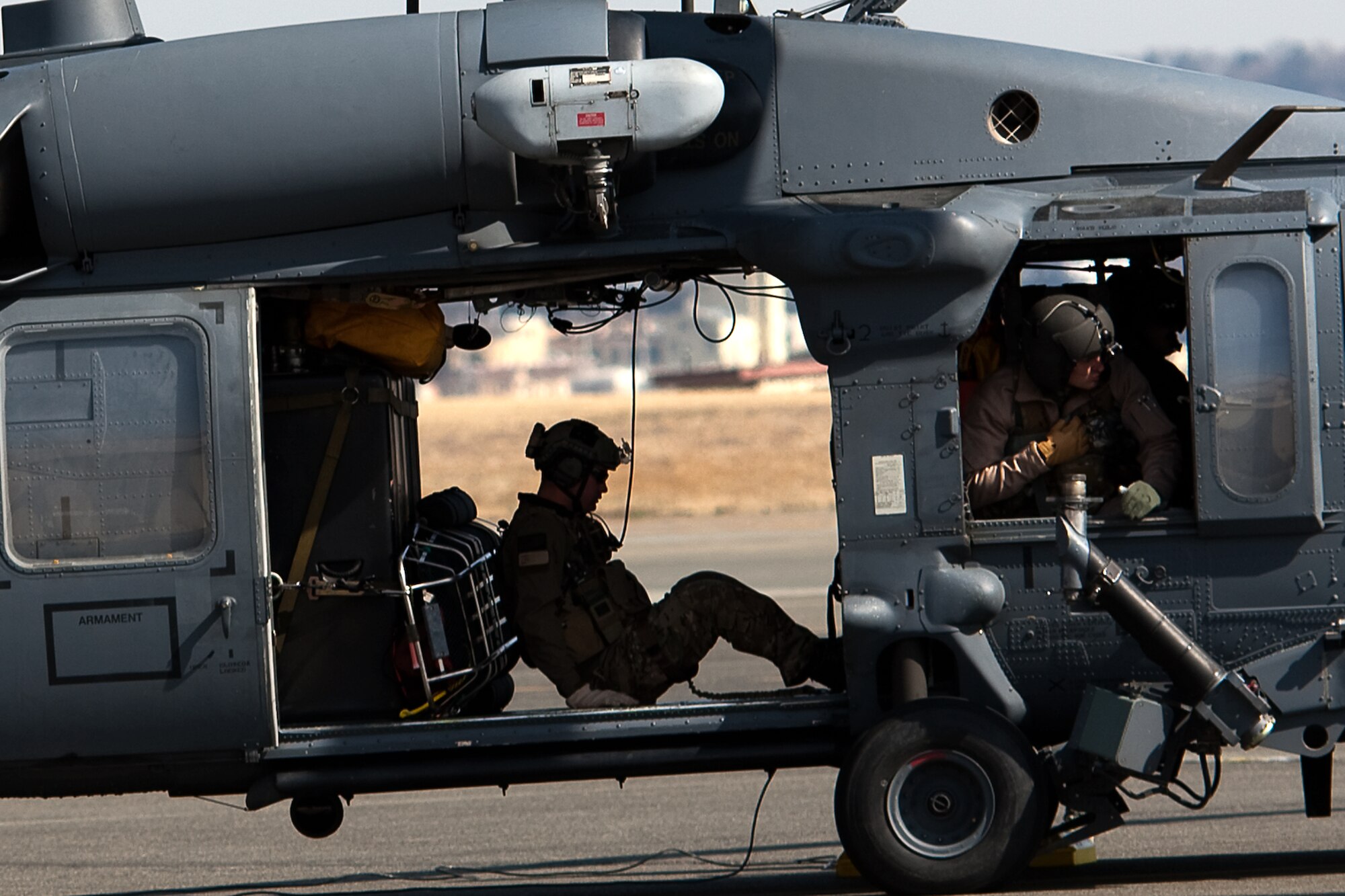 YOKOTA AIR BASE, Japan -- A joint team of Air Force and Marine search and rescue member boards an HH-60 Pave Hawk helicopter to depart on search and rescue missions here March 14. Yokota is receiving personnel, aircraft and supplies to support search and rescue efforts as requested by the government of Japan. (U.S. Air Force photo/Osakabe Yasuo)