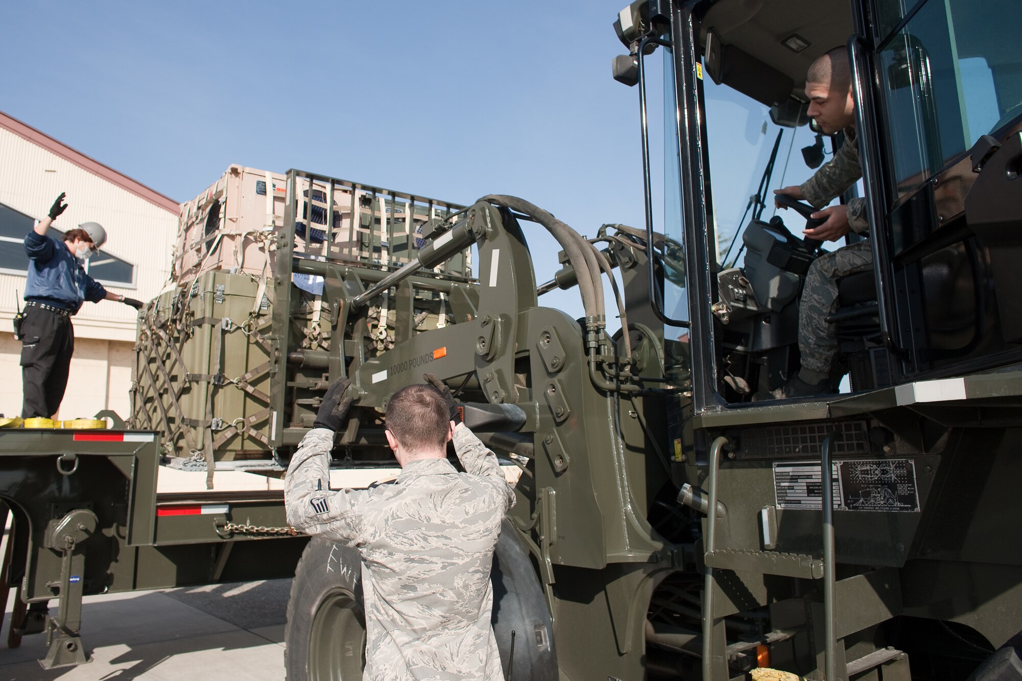 YOKOTA AIR BASE, Japan -- Members from the 374th Logistics Readiness Squadron unload cargo here, March 14, to assist the earthquake and tsunami recovery effort.  (U.S. Air Force photo/Osakabe Yasuo)