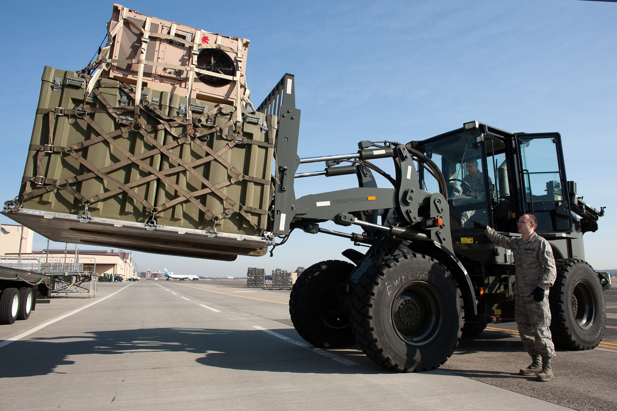 YOKOTA AIR BASE, Japan -- Members from the 374th Logistics Readiness Squadron unload cargo here, March 14, to assist the earthquake and tsunami recovery effort.  (U.S. Air Force photo/Osakabe Yasuo)
