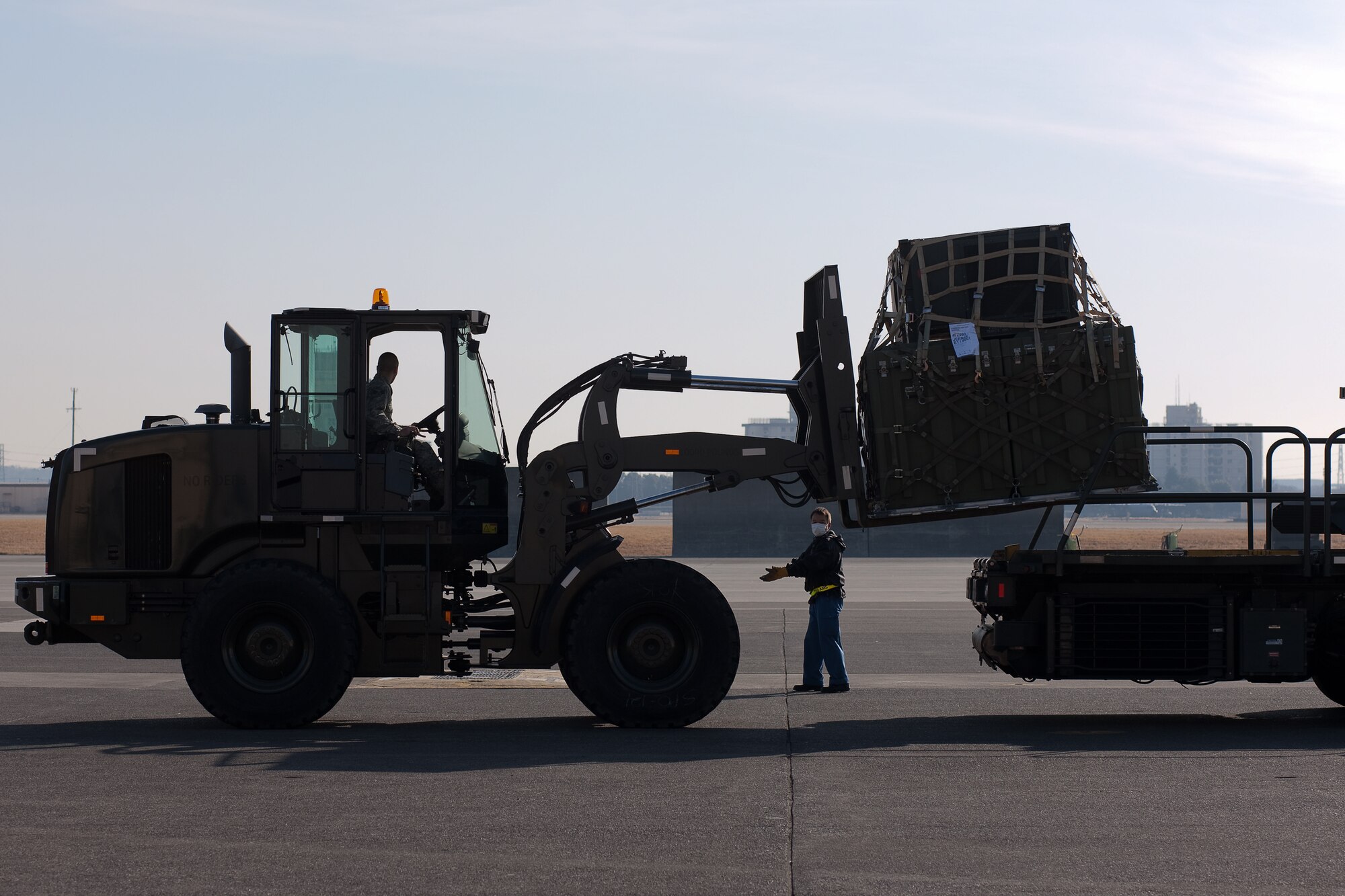 YOKOTA AIR BASE, Japan -- Members from the 374th Logistics Readiness Squadron unload cargo from K-loader here March 14, to assist the earthquake and tsunami recovery effort. (U.S. Air Force photo/Osakabe Yasuo)
