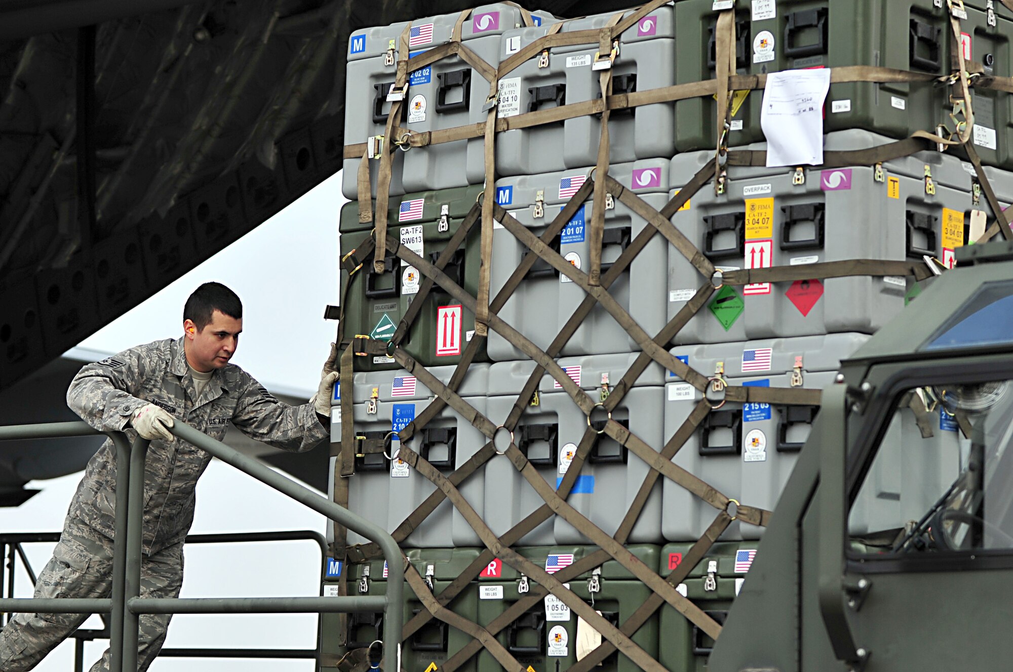 MISAWA AIR BASE, Japan -- U.S. Air Force Staff Sgt. James Anderson off loads pallets of humanitarian relief supplies onto a 25K loader Mar. 13. Search and rescue teams from Los Angeles County Fire Department came out in support of Operation Tomodachi after an 8.9 magnitude earthquake hit 100 miles off the coast of Northern Japan Mar. 11.  Sergeant Anderson is assigned to the 35th Logistics Readiness Squadron. (U.S. Air Force photo by Staff Sgt. Marie Brown\Released)

