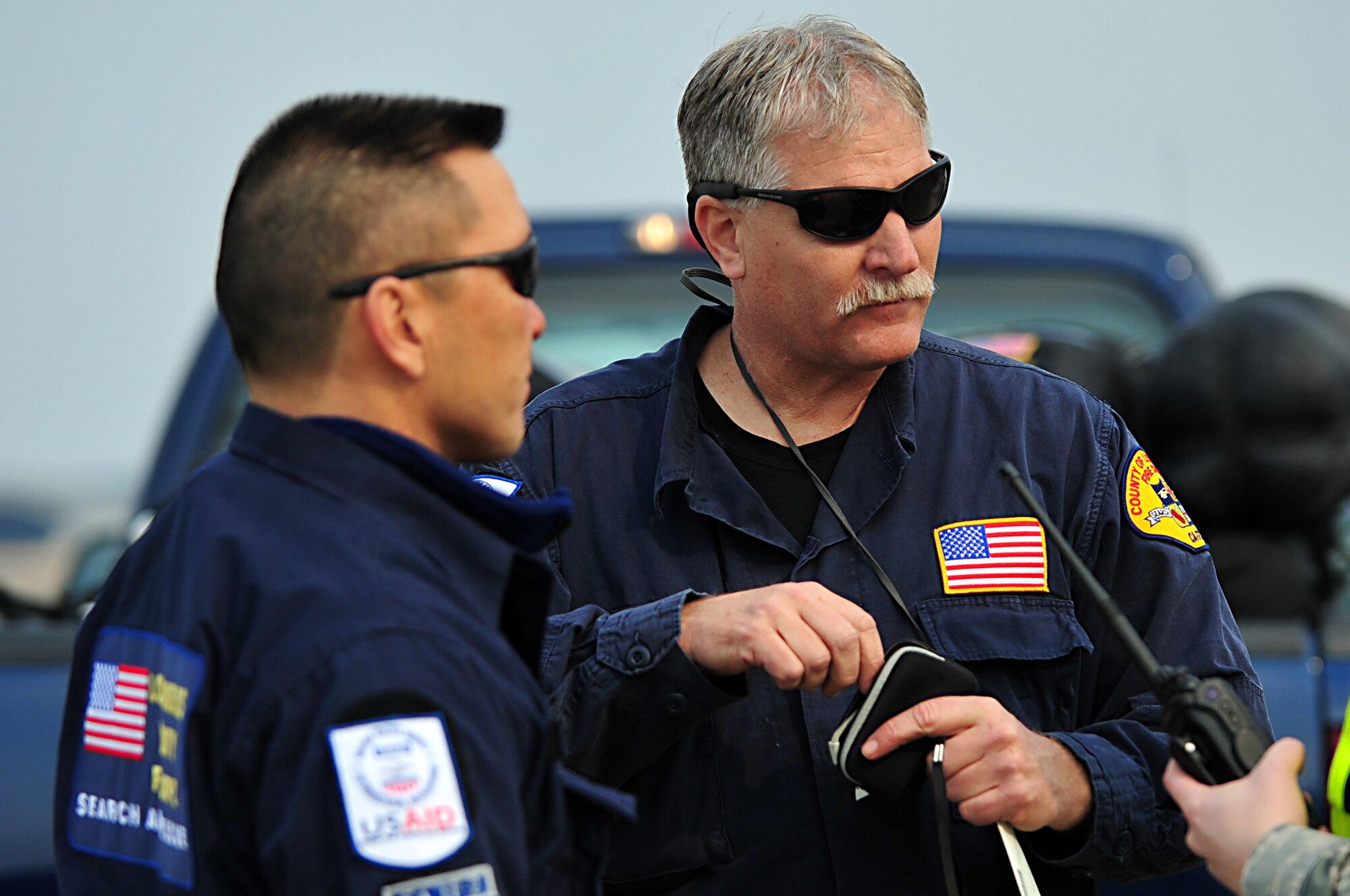 MISAWA AIR BASE, Japan -- U.S. Agency for International Development workers from the Los Angeles County Fire Department receive a briefing after arriving Mar. 13.  The team arrived in support of Operation Tomodachi after an 8.9 magnitude earthquake hit 100 miles off the coast of Northern Japan Mar. 11, 2011. (U.S. Air Force photo by Staff Sgt. Marie Brown\Released)
