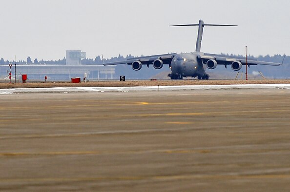 MISAWA AIR BASE, Japan -- A U.S. Air Force C-17 Globe Master III, arrives here carrying search and rescue workers to assist in civil relief recovery operations Mar. 13. The search and rescue team is from the Los Angeles County Fire Department, Calif. (U.S. Air Force photo by Staff Sgt. Marie Brown\Released)
