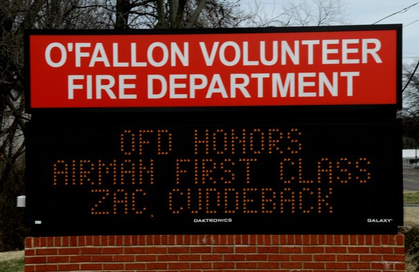 A sign on a local business near Scott Air Force Base, Ill. honors Airman 1st Class Zachary Cuddeback who was killed, along with another Airman, when a man opened fire on a bus of U.S. Airmen at an airport in Frankfurt, Germany March 2, 2011. Airman Cuddeback will be laid to rest next to his grandfather at a cemetery in O'Fallon, Ill. (U.S. Air Force photo/Staff Sgt. Brian J. Valencia)