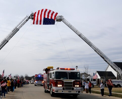 Local emergency vehicles lead the procession route of Airman 1st Class Zachary Cuddeback March 12, 2011 in O’Fallon, Ill. Airman Cuddeback and another Airman were killed March 2, 2011 when a man opened fire on a bus of U.S. Airmen at an airport in Frankfurt, Germany. Airman Cuddeback will be laid to rest next to his grandfather at a cemetery in O'Fallon, Ill. (U.S. Air Force photo/Staff Sgt. Brian J. Valencia)