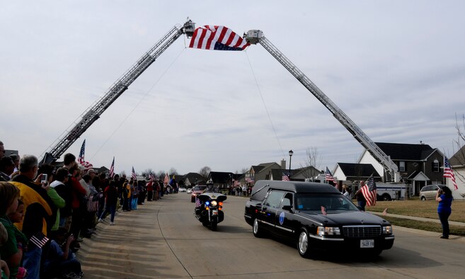 Hundreds of people lined the streets of a procession line for Airman 1st Class Zachary Cuddeback to show respect for a fallen hero March 12, 2011 in O’Fallon, Ill. Airman Cuddeback and another Airman were killed March 2, 2011 when a man opened fire on a bus of U.S. Airmen at an airport in Frankfurt, Germany. Airman Cuddeback will be laid to rest next to his grandfather at a cemetery in O'Fallon, Ill. (U.S. Air Force photo/Staff Sgt. Brian J. Valencia)