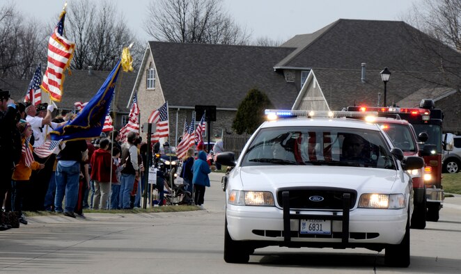 Local emergency vehicles lead the procession route of Airman 1st Class Zachary Cuddeback March 12, 2011 in O’Fallon, Ill. Airman Cuddeback and another Airman were killed March 2, 2011 when a man opened fire on a bus of U.S. Airmen at an airport in Frankfurt, Germany. Airman Cuddeback will be laid to rest next to his grandfather at a cemetery in O'Fallon, Ill. (U.S. Air Force photo/Staff Sgt. Brian J. Valencia)