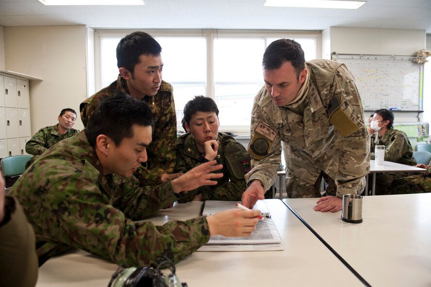 YAMAGATA, Japan -- Maj. John Traxler, 320th Special Tactics Squadron commander and members of the Japan Ground Self-Defense Force discuss the possibility of using Yamagata as a fuel staging area here March 13. The area would be used to refuel aircraft assisting with Japan's earthquake and tsunami recovery efforts. (U.S. Air Force photo/Staff Sgt. Samuel Morse)