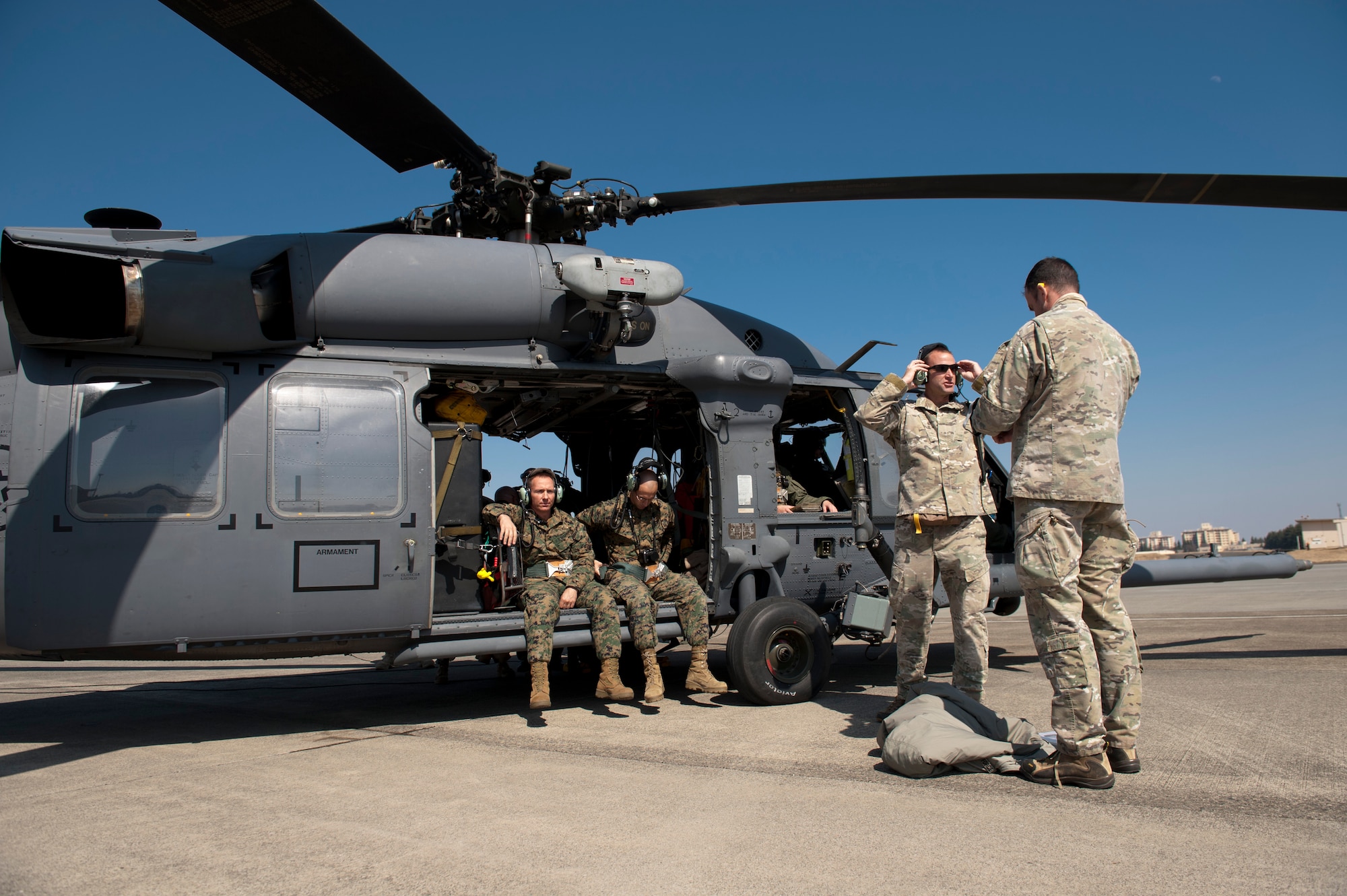 YOKOTA AIR BASE, Japan -- Airlift leadership and a joint team of U.S. Air Force and Marine search and rescue members, prepare to board an HH-60 Pave Hawk helicopter from the 33rd Rescue Squadron here March 13. Yokota is receiving personnel, aircraft and supplies to support search and rescue efforts as requested by the government of Japan. (U.S. Air Force photo/Staff Sgt. Samuel Morse)
