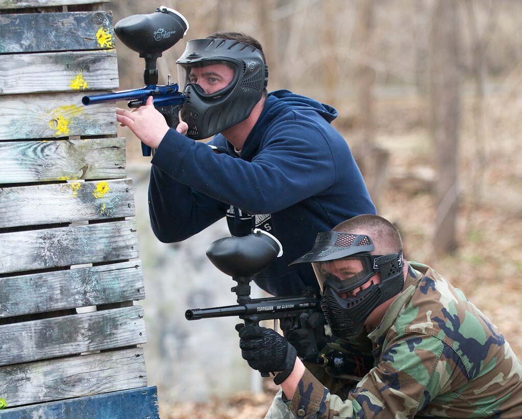 Staff Sgt. Antoine T. Dozier (left) and Senior Airman Adam G. Miller take defensive positions during the 932nd Medical Group paintball war Mar. 12, 2011 held at the paintball arena located on Scott Air Force Base, Il.  The event was organized by the 932nd Medical Squadron's social functions committee to promote morale and camaraderie.  (Air Force photo by Tech. Sgt. Christopher Parr)